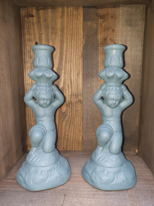 Pair of stone effect cherub candle holders