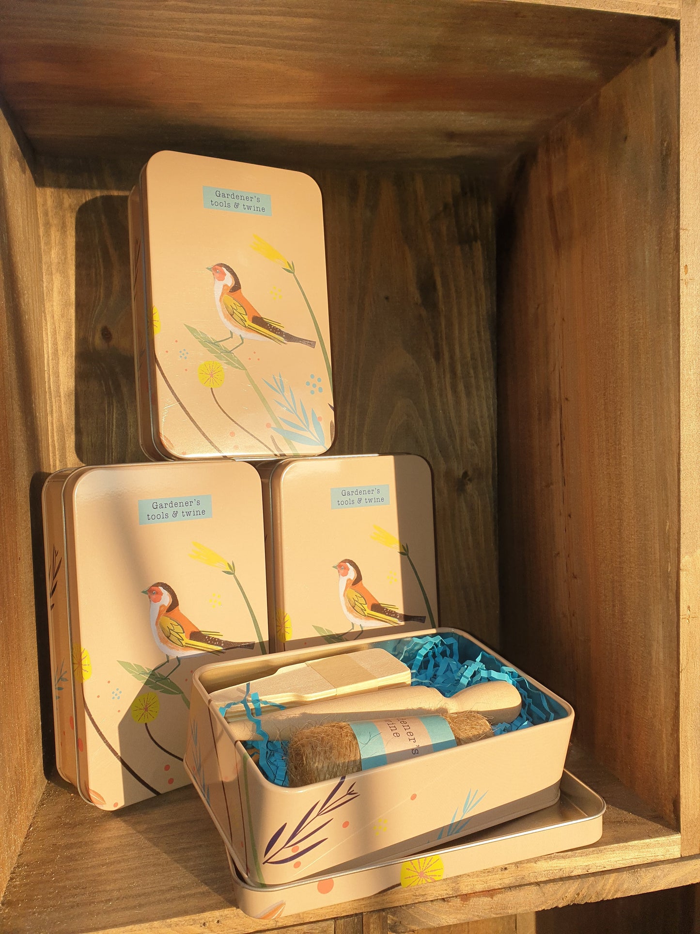 Gardeners tools and twine in a tin