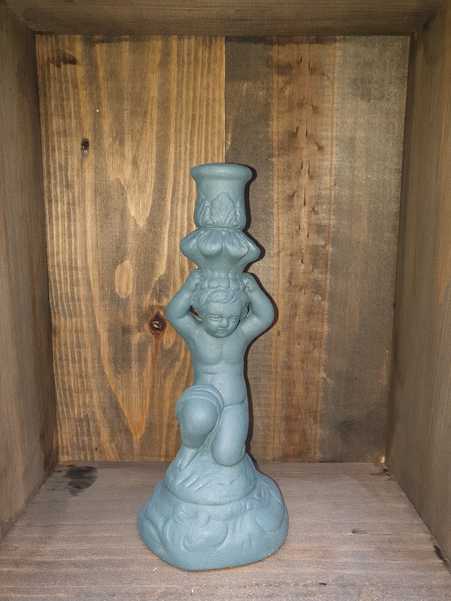 Pair of stone effect cherub candle holders