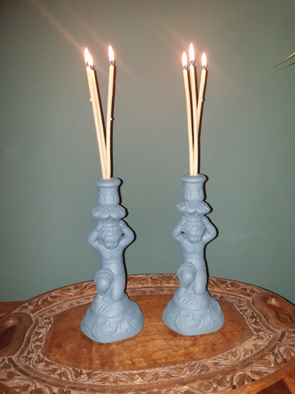 Pair of stone effect cherub candle holders